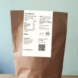 Bio Linsen Rot abgepackt in brauner Papiertüte mit Nährwertangaben auf weißem Zettel